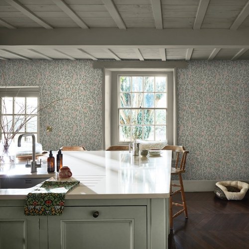Room shot with Bird & Pomegranate Rose Garden wallpaper in a styled interior