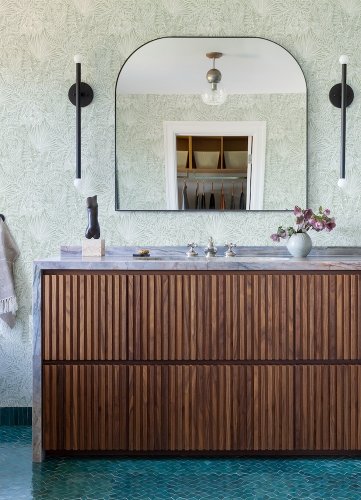 A Street Prints Vita Sage Wallpaper in a styled room with light green leafy design