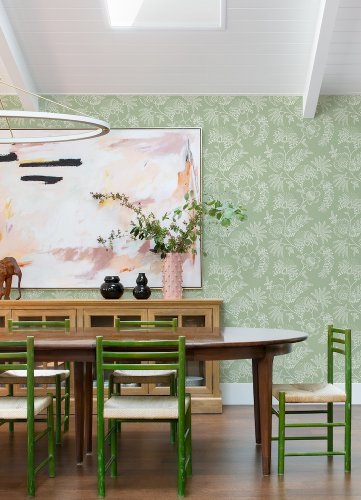 A Street Prints Maeve Sage Wallpaper styled in a modern dining room with green floral walls