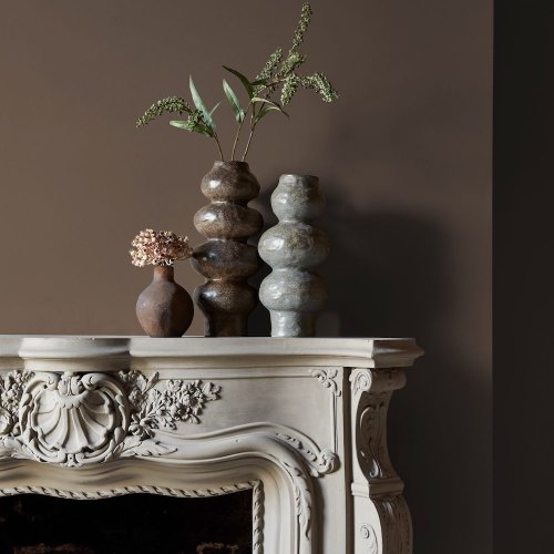 Fireplace wall painted in Abigail Ahern After Dawn with rich, ambient décor
