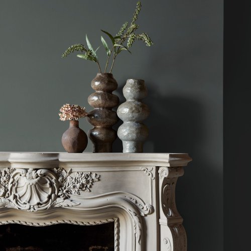 Fireplace wall painted in Abigail Ahern Dakota Mountain with rustic, natural textures