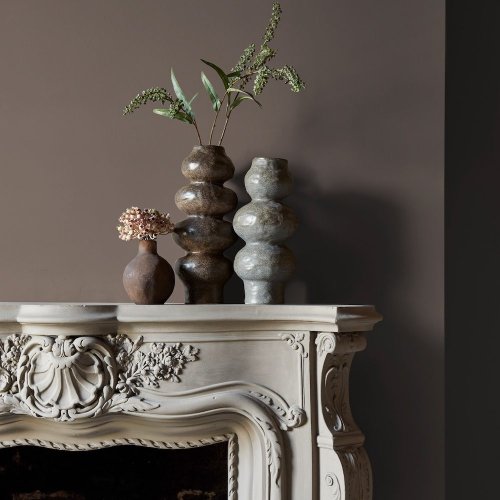 Fireplace wall painted in Abigail Ahern Dusk Falls with layered, contemporary décor