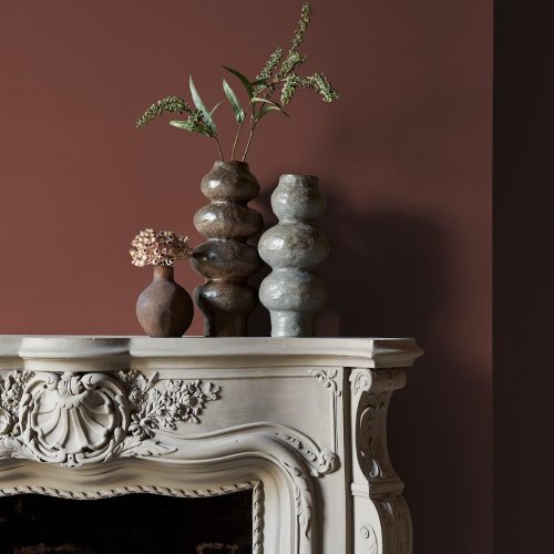 Fireplace wall painted in Abigail Ahern Earthen Nomad with bohemian, textural decor
