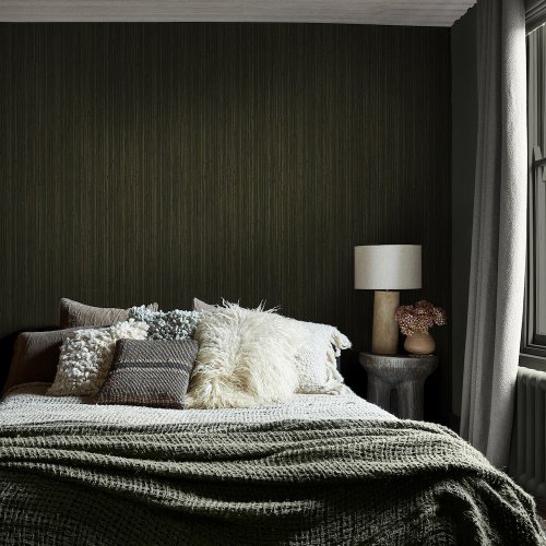 Room styled with Abigail Ahern Fibre Stripe Forest wallpaper in a warm, earthy interior