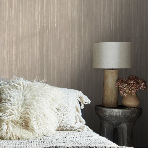 Room styled with Abigail Ahern Linear Luxe Deep Greige wallpaper in a warm, modern setting