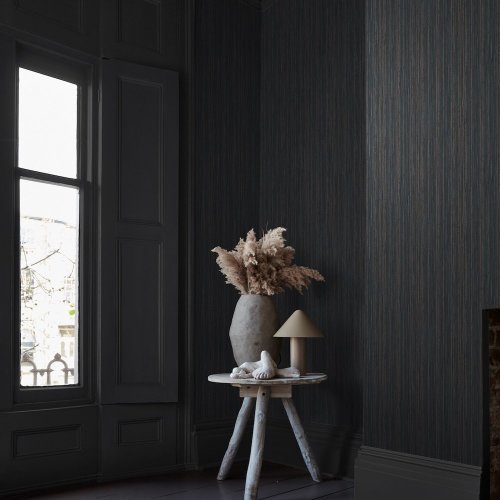 Room styled with Abigail Ahern Fibre Stripe Twilight wallpaper in a moody, refined setting