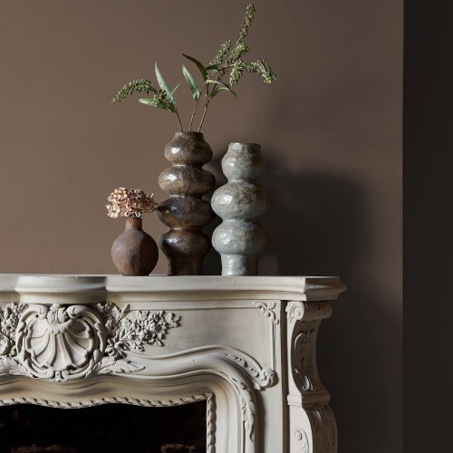 Fireplace wall painted in Abigail Ahern Flaxen Yarn with calming, layered textures