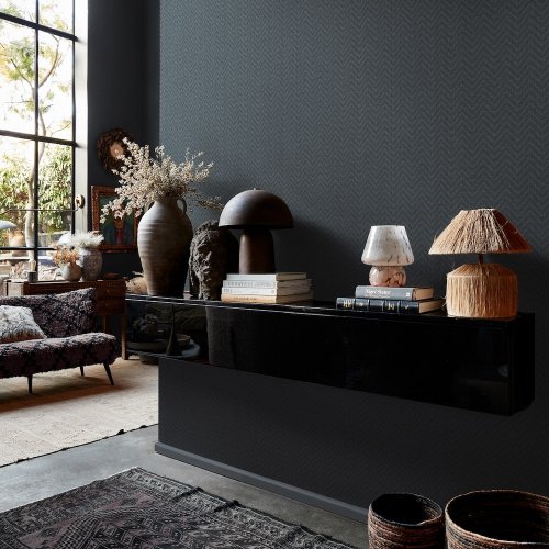 Room styled with Abigail Ahern Herringbone Weave Dusk wallpaper in a moody, elegant setting