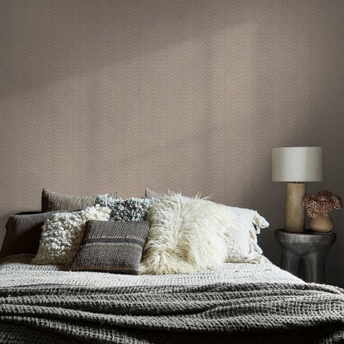 Room styled with Abigail Ahern Herringbone Weave Praline wallpaper in a soft, cosy setting