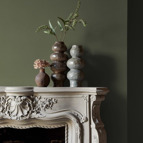 Fireplace wall painted in Abigail Ahern Kelp Harbour with earthy, layered textures