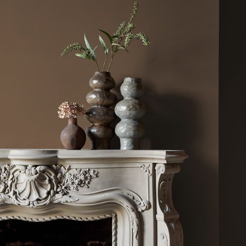 Fireplace wall painted in Abigail Ahern Owasco Olive with rustic-modern décor