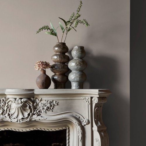 Fireplace wall painted in Abigail Ahern Loch Reeds with natural, refined décor