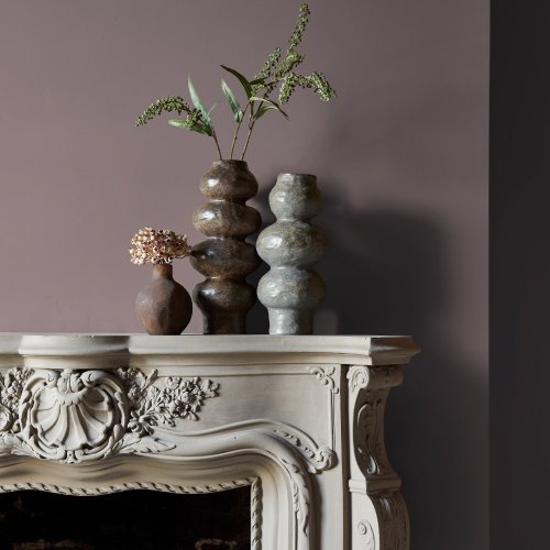 Fireplace wall painted in Abigail Ahern Sequoia Tree with rich, layered decor