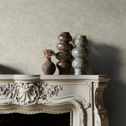 Room styled with Abigail Ahern Urbanite Tadelakt Greige wallpaper in a cool, minimalist setting