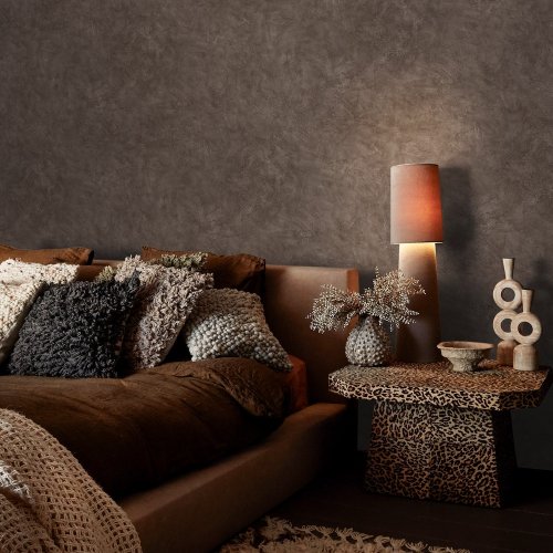 Room styled with Abigail Ahern Urbanite Tadelakt Ground wallpaper in a warm, minimalist setting