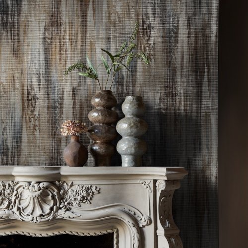 Room styled with Abigail Ahern Wanderlust Amber wallpaper in a warm, elegant setting