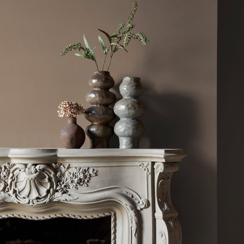 Fireplace wall painted in Abigail Ahern Weathered Linen with natural, layered textures