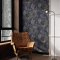 Room scene with Solstice Navy Copper wallpaper and bold interior styling