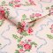 Roll shot of Rose Flutter Pink wallpaper with soft floral detail