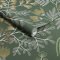 Roll of Superfresco Easy Richmond Forest Green Wallpaper showing deep green base with white botanical line drawings and ochre accents.