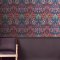 Room styled with Dove & Rose Carnival wallpaper in a vibrant, artistic setting