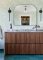 A Street Prints Vita Sage Wallpaper in a styled room with light green leafy design