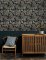 A Street Prints Caspian Charcoal Wallpaper with a dark jungle theme, featuring detailed foliage and prowling tigers for a striking interior look.