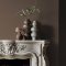 Fireplace wall painted in Abigail Ahern After Dawn with rich, ambient décor