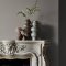 Fireplace wall painted in Abigail Ahern Anise Greige with calm, organic décor
