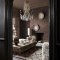 Room styled with Abigail Ahern Boheme Marble Mocha wallpaper in a rich, earthy interior