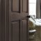 Painted door in Abigail Ahern Dewdrop Moss with warm, grounding interior styling