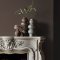 Fireplace wall painted in Abigail Ahern Dewdrop Moss with cosy, layered textures