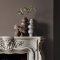 Fireplace wall painted in Abigail Ahern Dusk Falls with layered, contemporary décor