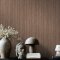 Room styled with Abigail Ahern Fibre Stripe Sable wallpaper in a warm, sophisticated interior