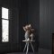 Room styled with Abigail Ahern Fibre Stripe Twilight wallpaper in a moody, refined setting