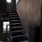 Room styled with Abigail Ahern Linear Luxe Deep Greige wallpaper in a warm, modern setting