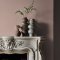 Fireplace wall painted in Abigail Ahern Monterey Blush with soft, warm-toned décor