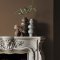 Fireplace wall painted in Abigail Ahern Owasco Olive with rustic-modern décor
