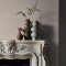 Fireplace wall painted in Abigail Ahern Loch Reeds with natural, refined décor