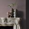 Fireplace wall painted in Abigail Ahern Sequoia Tree with rich, layered decor