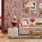 Room decorated with Strawberry Garden Rose wallpaper, featuring vibrant strawberries and roses against a soft pink backdrop.