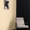 Room setting with Craig & Rose Adam Cream on the walls and Regency-inspired decor