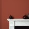Room painted in Craig & Rose Arabian Red with warm, moody styling