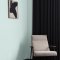 Interior room painted in Craig & Rose Porcelain Blue with classic, airy styling