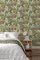 Paul Moneypenny Floral Hall wallpaper styled in a modern room with vibrant tropical print and soft green tones.